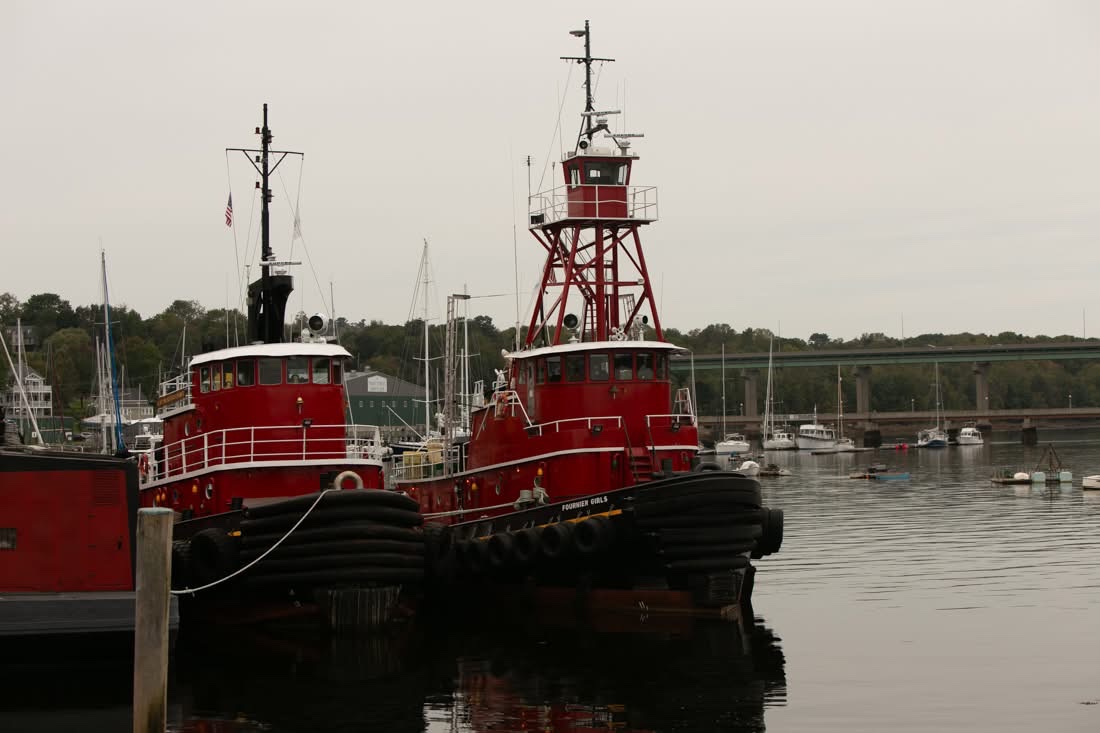 Red tugboats docked in harbor